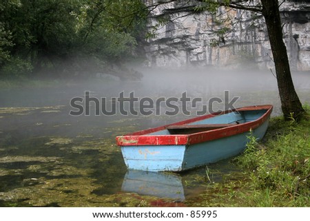 colorful boat on fog clouded lake