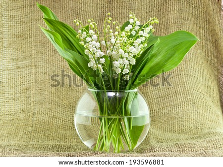 Bouquet of lily of the valley in a round vase