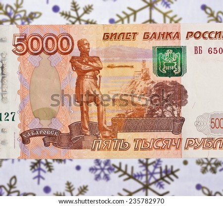 Russian 5000 ruble bank note on the background of snowflakes