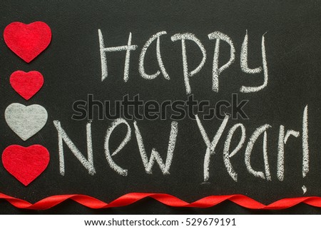 Happy New Year message greeting handwriting on a blackboard