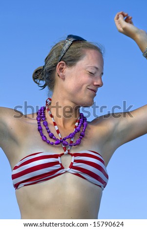 Young attractive woman dancing in a bikini.