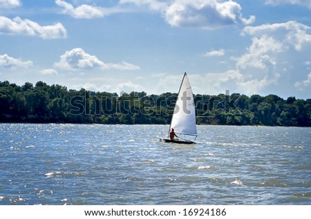 Small sailboat gliding across the water.
