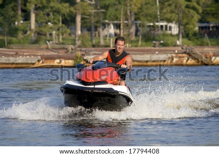 Man riding wave runner on a beautiful summer day.