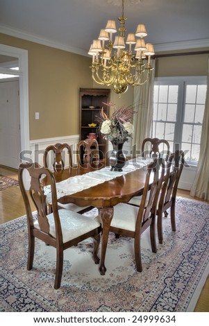 Luxurious wooden dining room table and chairs in a modern home.