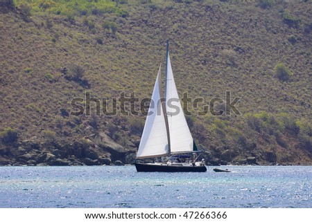 Large luxurious boat sailing through the tropics.