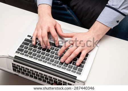 Man\'s hands typing on laptop. Internet surfing. Programming code