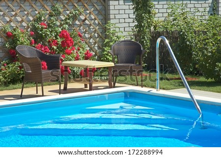 pool with lounge area and garden patio furniture