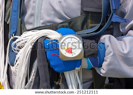 Hand in glove with the parachutist altimeter close up.