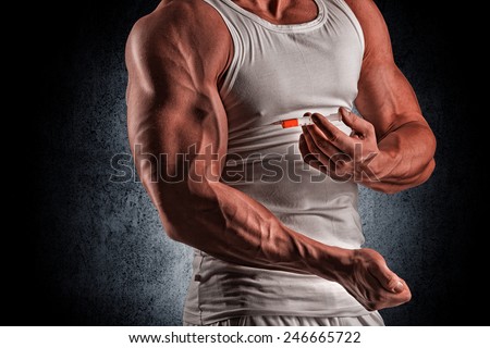 muscular man doing a shot in the biceps, steroids, pharmacology