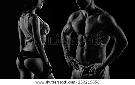 young muscular guy in the studio, posing for the camera with girl