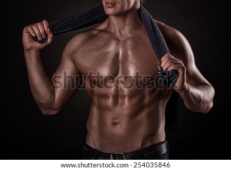 young handsome muscular guy with a towel around his neck