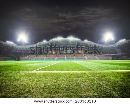 a football stadium with fans in the evening