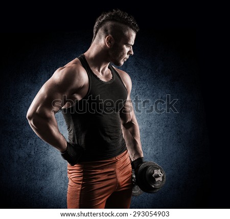 Strong bodybuilder with six pack, perfect abs, shoulders, biceps, triceps and chest. Image with clipping path