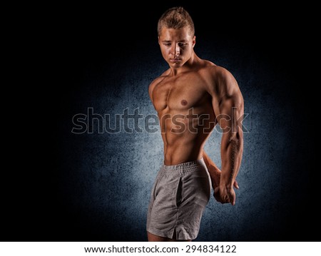 young muscular guy in the studio, posing for the camera