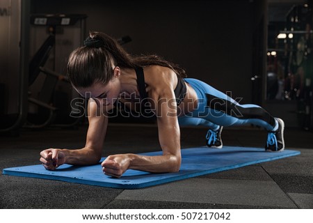 fitness girl exercising with barbell in gym