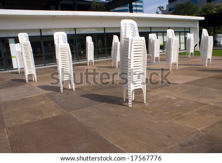 Stacks of white chair outdoor in park