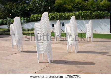 Stacks of white chair outdoor in park