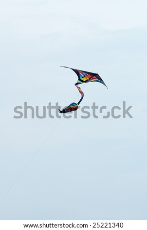 colorful delta kite in action in the blue sky