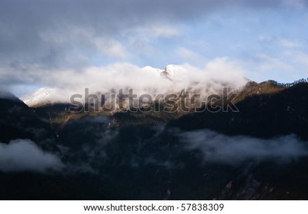 mountain landscape with green trees covered and white cloudscape