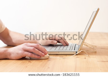 Close-up of hand on mouse of a young man searching information on internet with white background