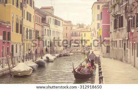 Venice, Italy - August 15, 2015. Vintage image of the popular Venice with one of its famous canals. Venice is a popular destination with tourists from all around the world.