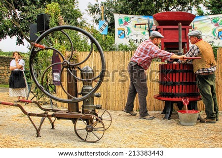 CHUSCLAN, FRANCE - October12, 2013: Traditional Wine Pressing using a manual grape crushing machine during the festival grape harvest of the history October 12 and 13, 2013, in Chusclan, France.