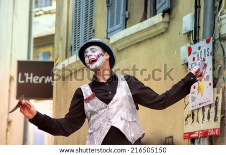 AVIGNON, FRANCE - JULY 19, 2014: Actor on stilts advertising his performance during famous theatre festival from July 4 to 27, 2014 in Avignon, south of France.
