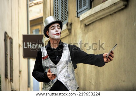 AVIGNON, FRANCE  JULY 19, 2014: Actor in historical costume advertising his performance during famous theatre festival from July 4 to 27, 2014 in Avignon, south of France.