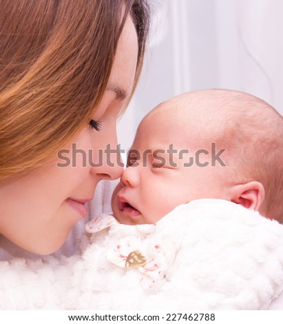 Mother holds cute newborn baby