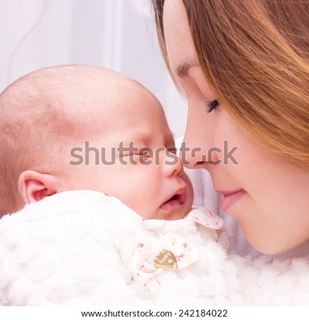 Mother holds cute newborn baby