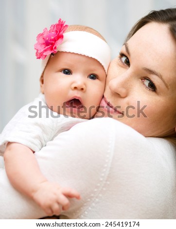 Mother holds cute 3 months baby