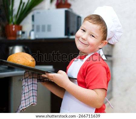 Cute boy making bread in the kitchen