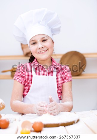 Cute girl making bread in the kitchen