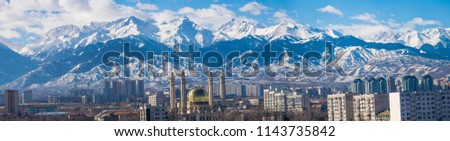 Amazing good day with clouds over the Almaty city near the Tian Shan mountains in winter. Best place for active life, vacation, hiking and trekking in Kazakhstan. Best view from the window.