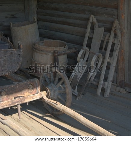 Ancient rural coach-house interior with wooden cart