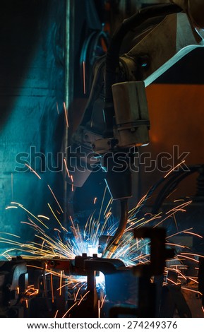 robots welding in a car factory