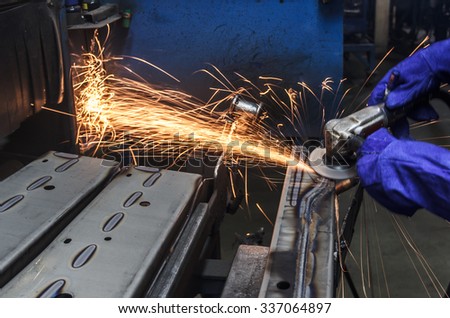 Sparks movement while grinding iron in factory