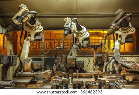 Robots welding team in the automotive parts industry