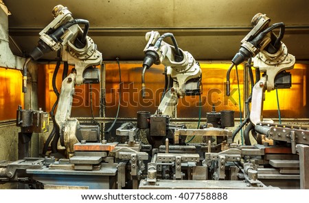 Robots welding team in the automotive parts industry