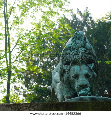 Lion statue sniffing its human meal at the Jardin des Plantes, Paris