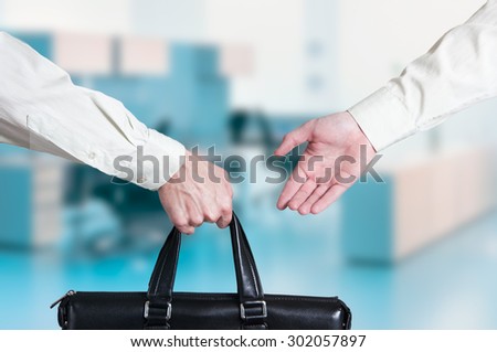business transfer deal. handover of a suitcase for money partners.