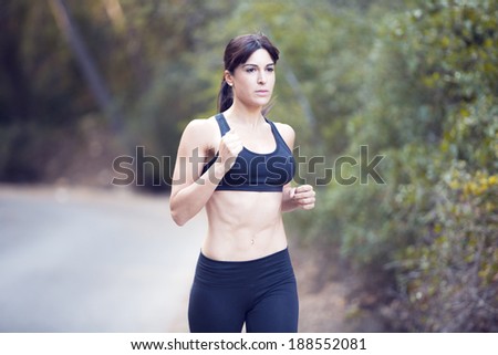 Picture of a woman running through the park.
