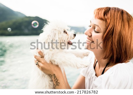 Woman with her dog during a day on Lake