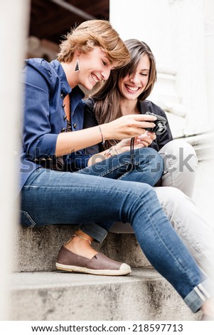 Best friends looking at pictures on camera
