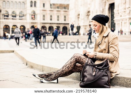 Portrait of a blonde woman writing diary