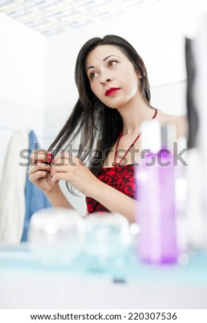 Woman doing morning routine in bathroom.