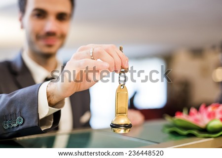 Businessman is getting room key after checking in to a hotel.