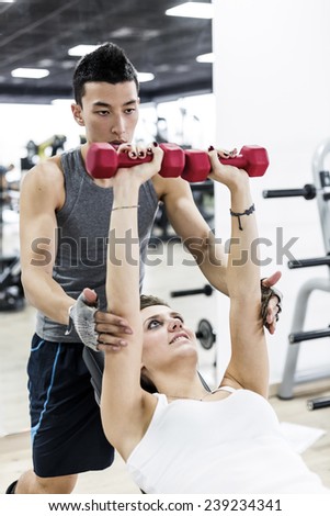 Exercises with Personal trainer in Health Club.