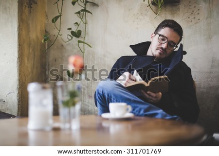Man reading a book during coffee break