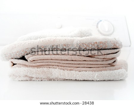 Pile of folded towels on a clothes dryer.